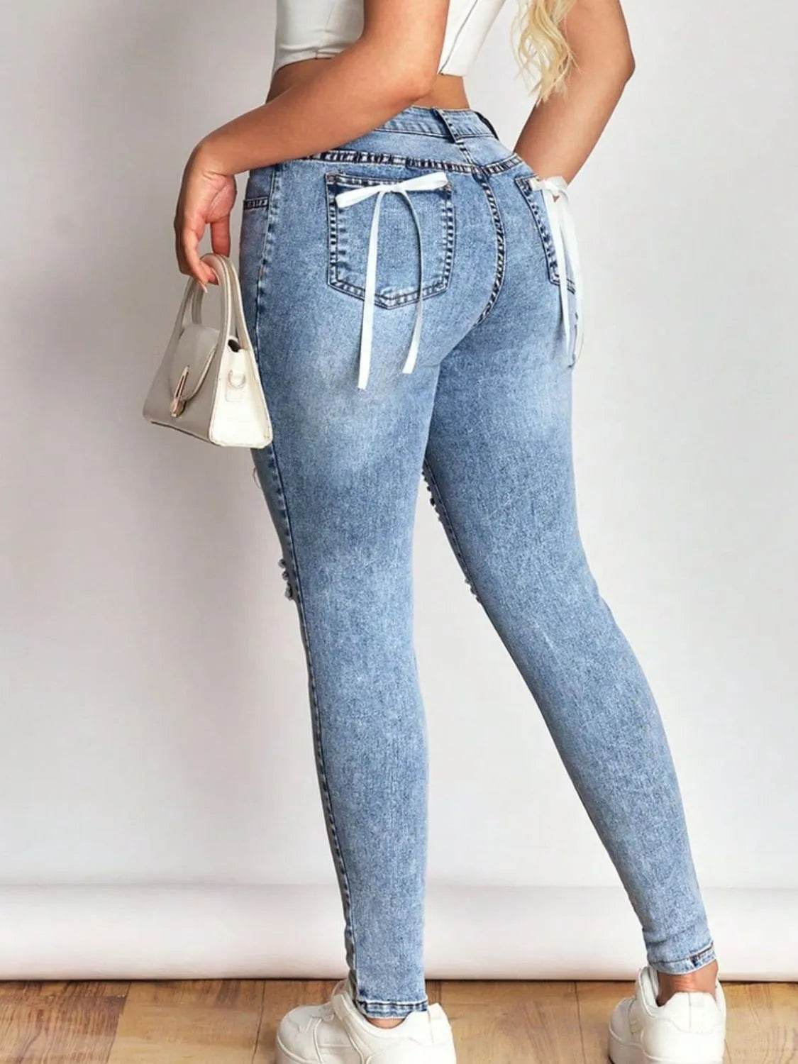Distressed Skinny Jeans with Bow Back Trendsi 125e6e0c-f4aa-4f39-bdd4-0edd4a43ce57-Max-Origin