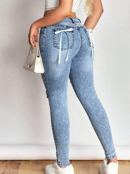 Distressed Skinny Jeans with Bow Back Trendsi 125e6e0c-f4aa-4f39-bdd4-0edd4a43ce57-Max-Origin