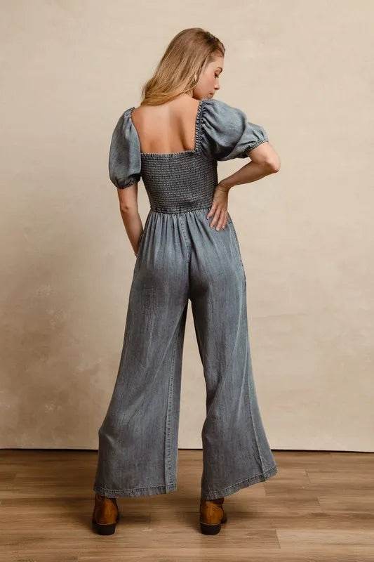 BiBi Smocked Washed Puff Sleeve Square Neck Denim Jumpsuit Trendsi 9c69e521-94a9-4c55-9624-21d10fe13353-Max-Origin